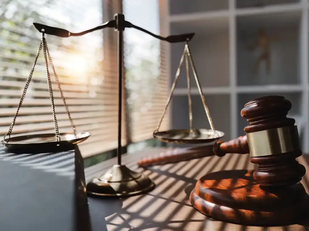 Scales of justice and a gavel on a lawyer's desk