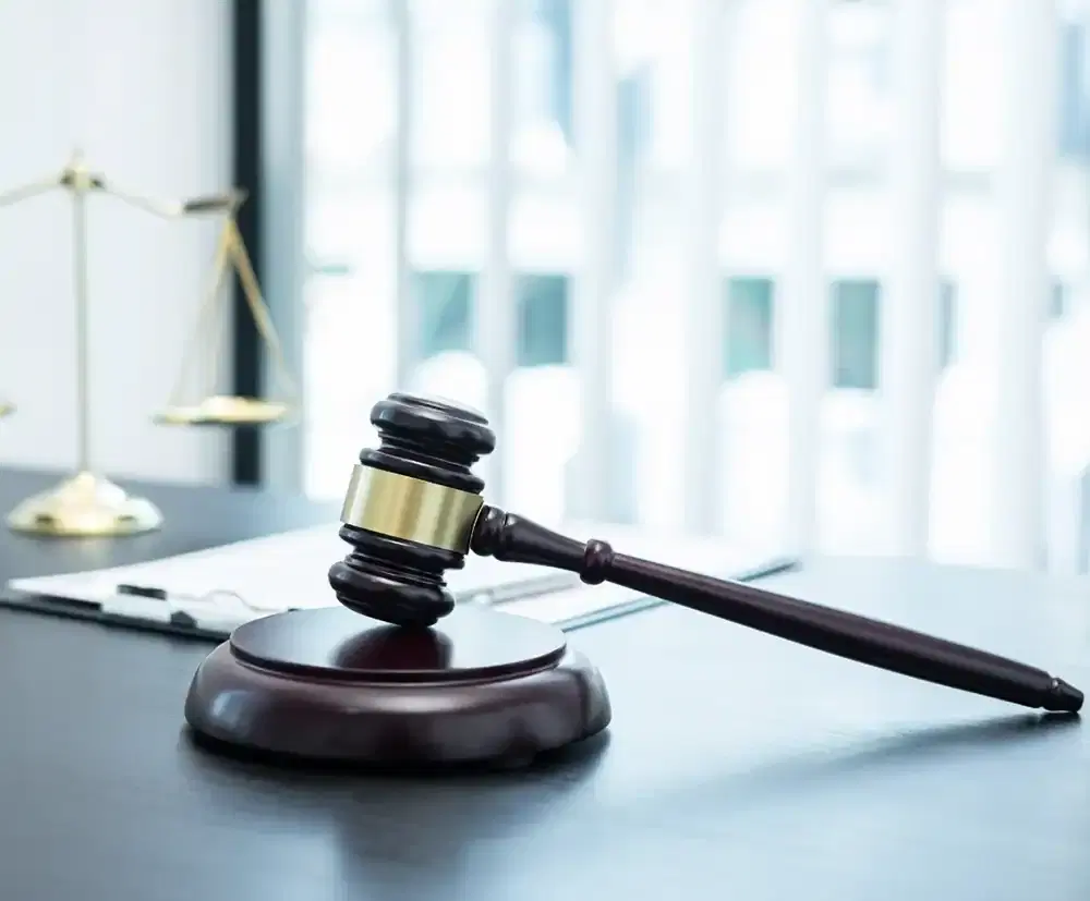 Judge's gavel on a desk beside legal documents